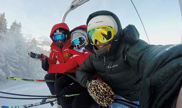 Tri skijaša pod opremom na stazi