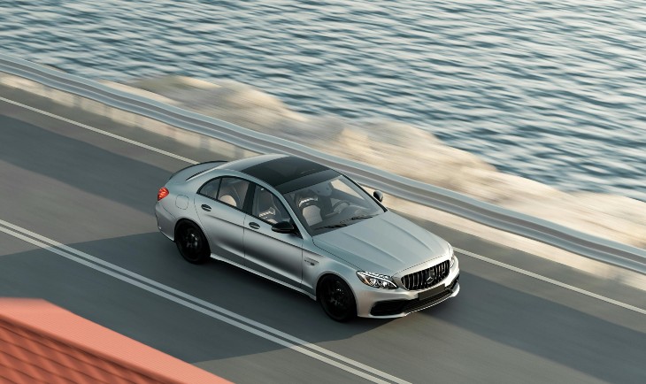 Sivi automobil vozi pored mora